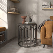 Front facing contemporary black natural stone and metal round end table in a room with accessories