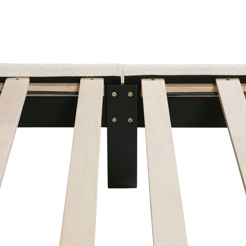 Front facing close up of the interior side rail, slats, and support leg of a modern white boucle upholstered queen bed on a white background