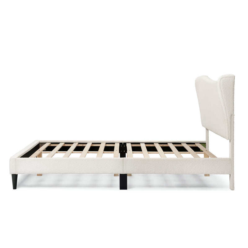 Front facing side view of a modern white boucle upholstered queen bed on a white background