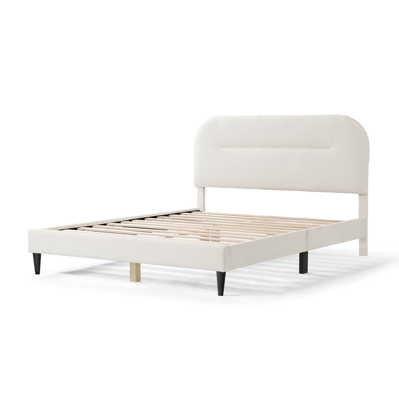 Left facing modern white boucle upholstered queen bed on a white background