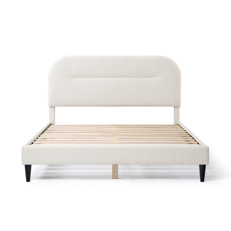 Front facing modern white boucle upholstered queen bed on a white background