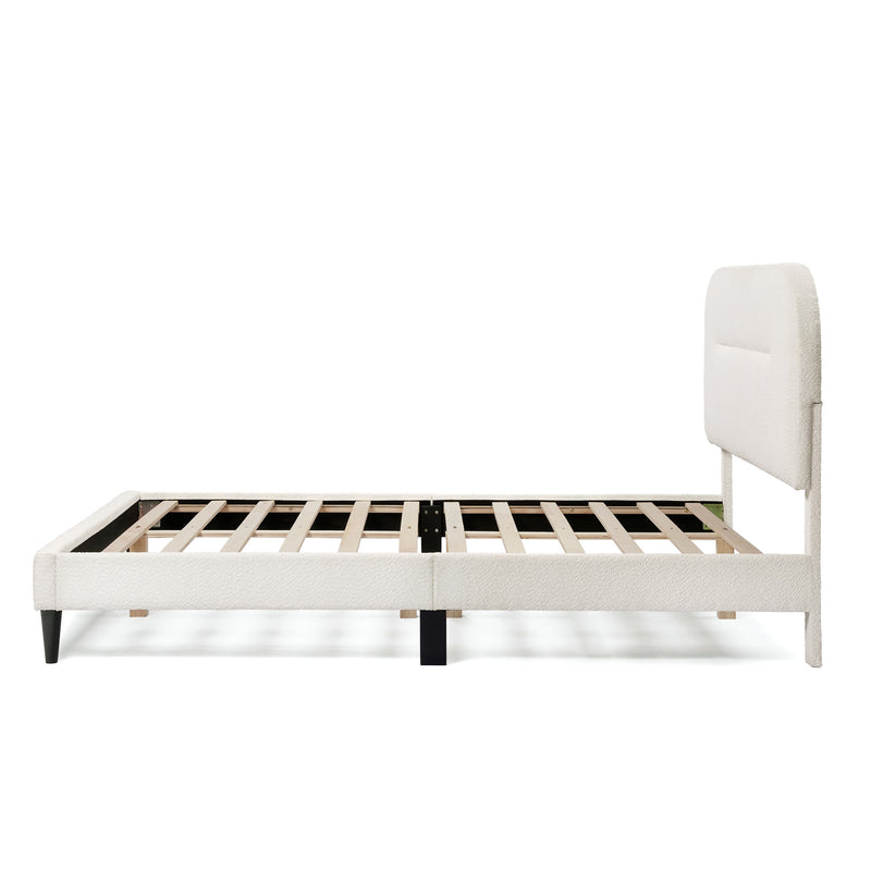 Front facing side view of a modern white boucle upholstered queen bed on a white background