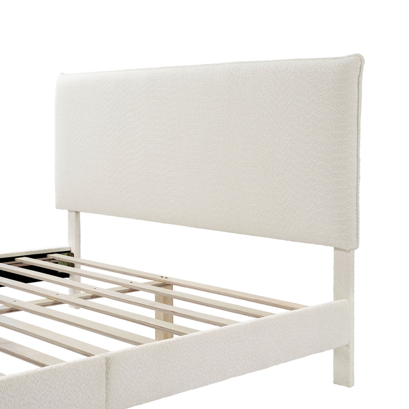 Left facing close up view of a modern white boucle upholstered queen bed on a white background