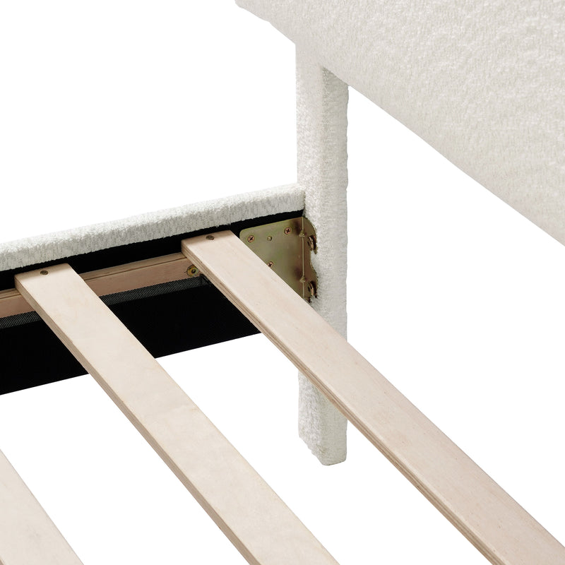 Left facing close up of the interior side rail, slats, and headboard of a modern white boucle upholstered queen bed on a white background