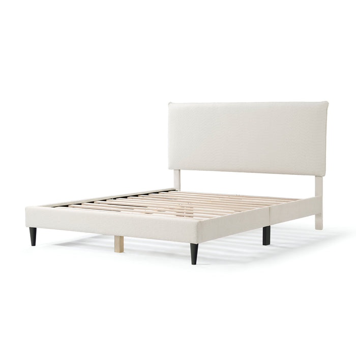 Left facing modern white boucle upholstered queen bed on a white background
