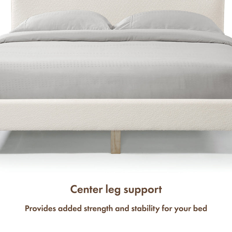 Front facing close up of a modern white boucle upholstered queen bed that highlights its center leg support