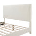 Left facing close up of the headboard of a modern white boucle upholstered queen bed on a white background