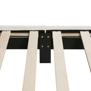 Front facing close up of the interior side rail, slats, and support leg of a modern white boucle upholstered queen bed on a white background