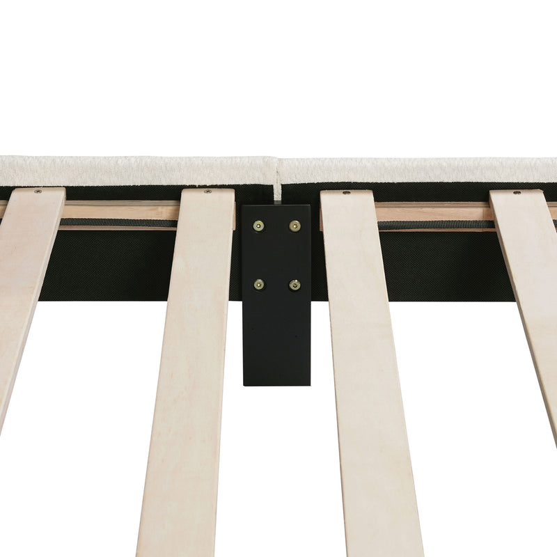 Front facing close up of the interior side rail, slats, and support leg of a modern white boucle upholstered queen bed on a white background