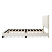 Front facing side view of a modern white boucle upholstered queen bed on a white background