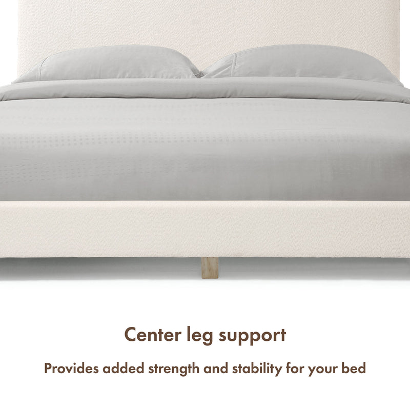 Front facing close up of a modern white boucle upholstered queen bed that highlights its center leg support
