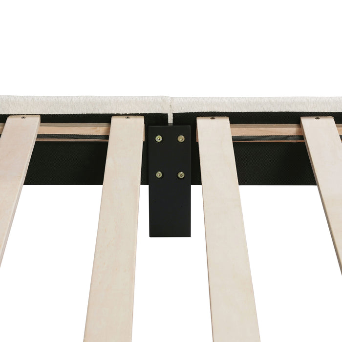 Left facing close up of the interior side rail, slats, and headboard of a modern white boucle upholstered queen bed on a white background