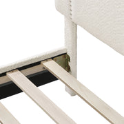 Left facing close up of the headboard and rails of a modern white boucle upholstered queen bed on a white background