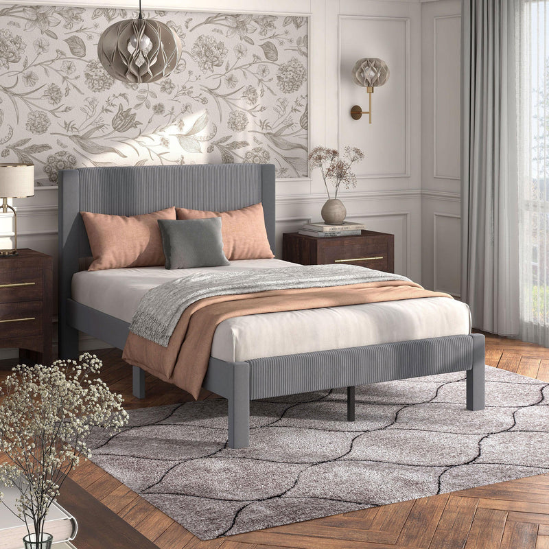 Right facing modern gray velvet textured headboard full platform bed in a room with linens and accessories
