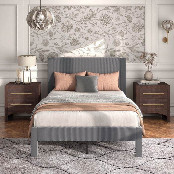 Front facing modern gray velvet textured headboard full platform bed in a room with linens and accessories