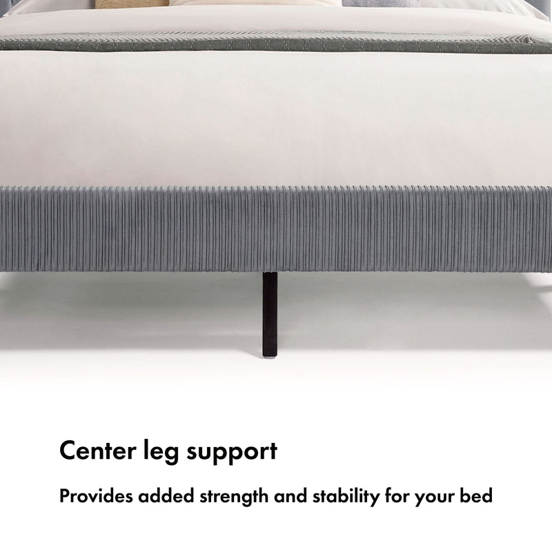 Front facing close up of the center leg support of a modern gray velvet textured headboard full platform bed on a white background