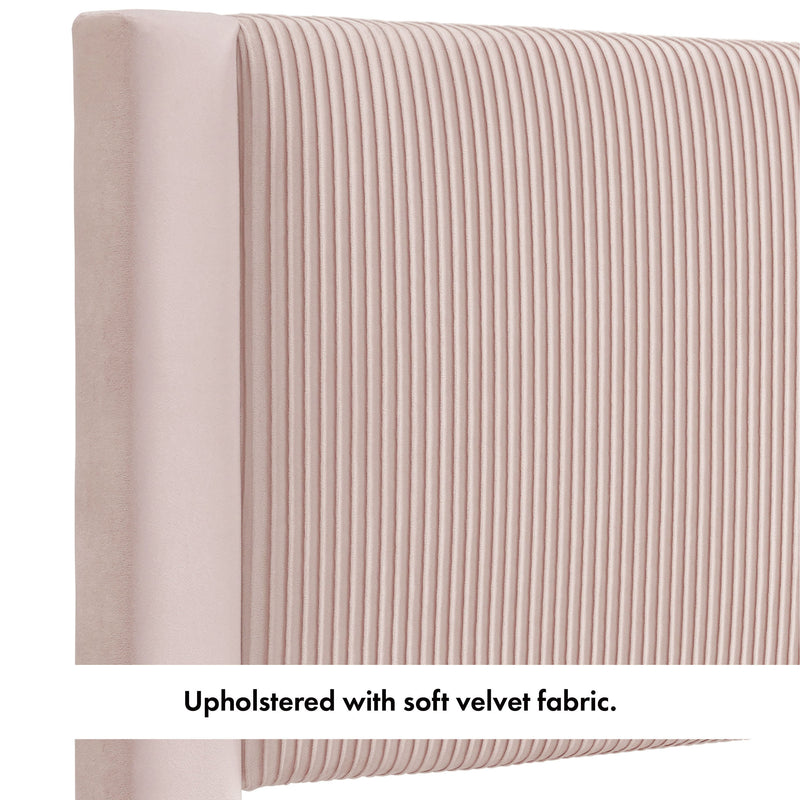 Right facing close up of the upholstered headboard of a modern gray velvet textured headboard full platform bed on a white background