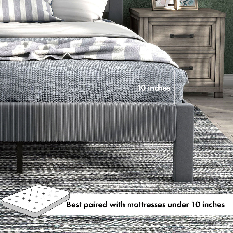 Right facing close up showing the mattress thickness of this modern gray velvet textured headboard full platform bed in a room with linens and accessories