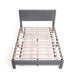 Front facing high-camera view of a modern gray velvet textured headboard queen platform bed on a white background