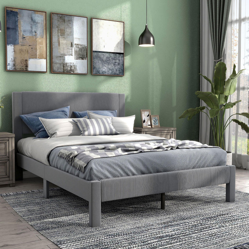 Right facing modern gray velvet textured headboard queen platform bed in a room with linens and accessories
