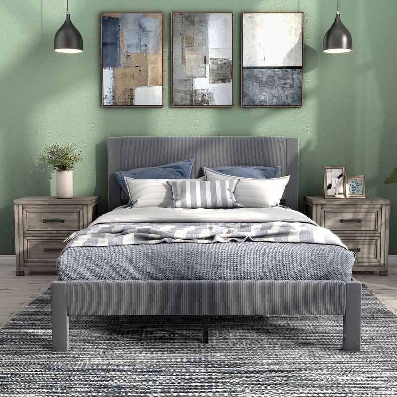 Front facing modern gray velvet textured headboard queen platform bed in a room with linens and accessories