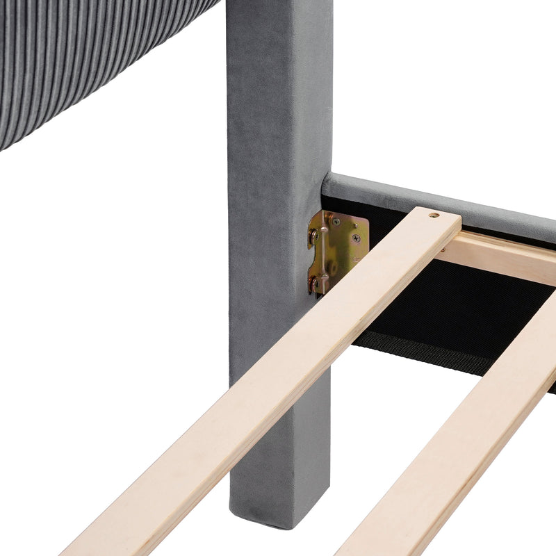 Right facing close up view of the headboard corner and slats on a modern gray velvet textured headboard queen platform bed on a white background