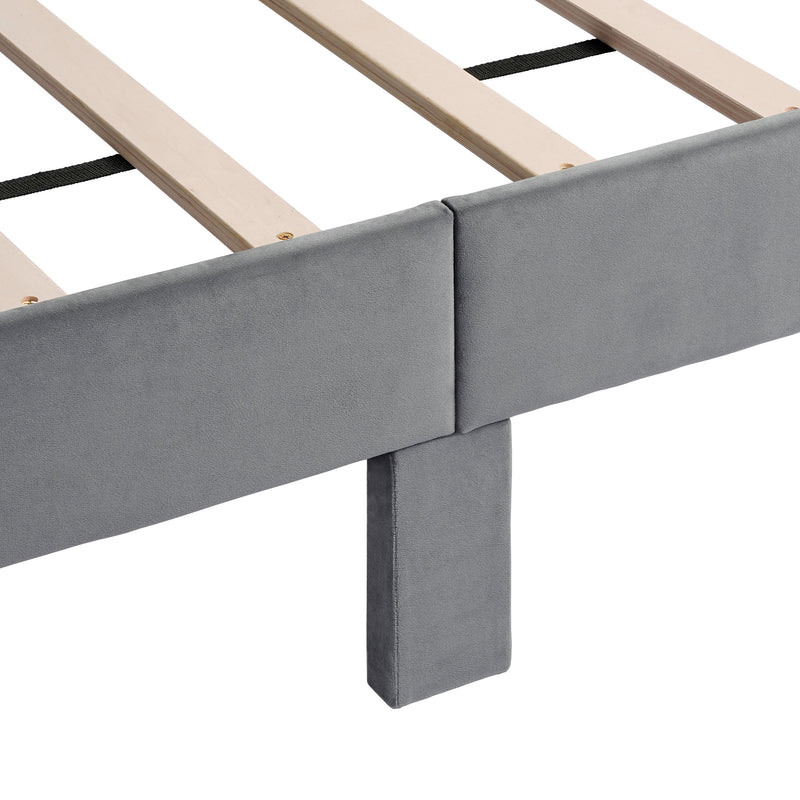 Right facing close up view of the support leg and slats on a modern gray velvet textured headboard queen platform bed on a white background