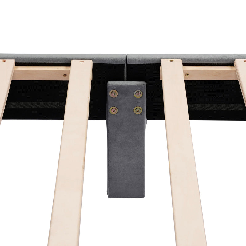 Front facing close up view of the interior support leg and slats on a modern gray velvet textured headboard queen platform bed on a white background