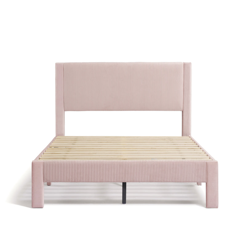Front facing modern pink velvet textured headboard full platform bed on a white background