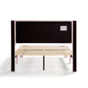 Front facing back view of a modern pink velvet textured headboard full platform bed on a white background