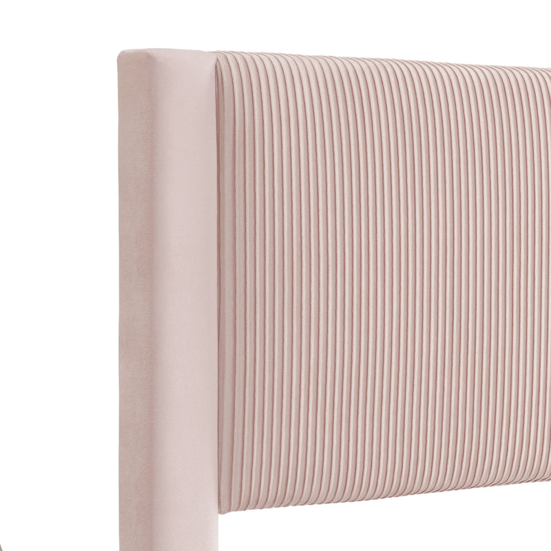 Right facing close up headboard view of a modern pink velvet textured headboard queen platform bed on a white background