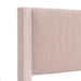 Right facing close up headboard view of a modern pink velvet textured headboard queen platform bed on a white background