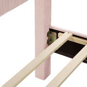 Right facing close up view of the headboard corner and slats on a modern pink velvet textured headboard queen platform bed on a white background