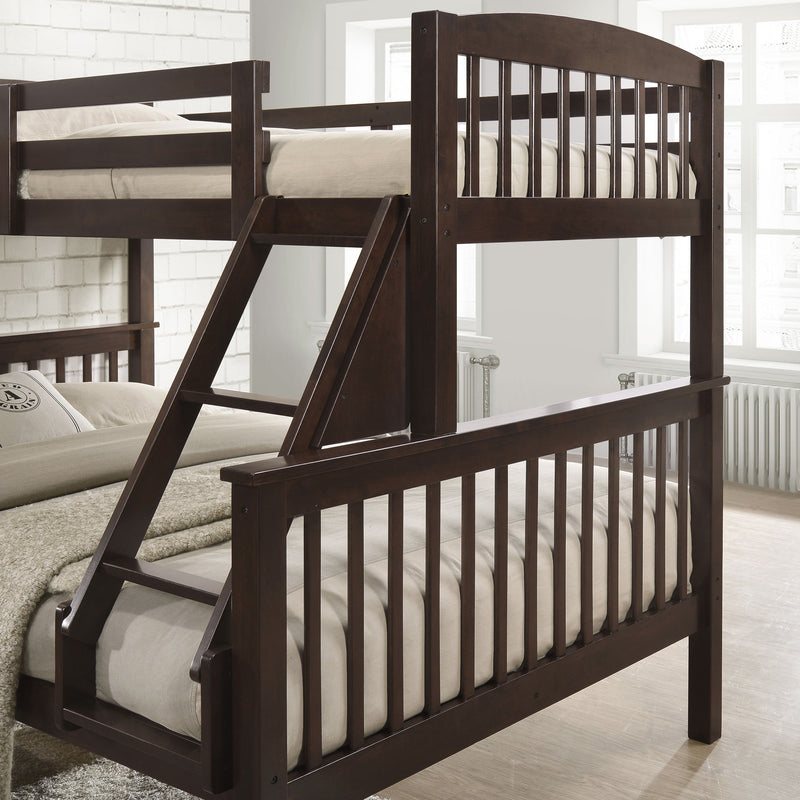 Left facing close up of the ladder and footboards of a Mission style twin-over-full dark brown wood bunk bed in a room with linens