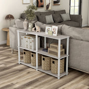 Left facing high-camera view of a four-shelf modular shelving unit with support rods in a room with accessories