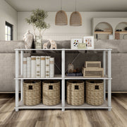 Front facing of a four-shelf modular shelving unit with support rods in a room with accessories