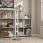 Right facing of two five-shelf modular shelving units with support rods in a room with accessories