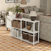 Left facing high-camera view of a four-shelf modular shelving unit with support rods in a room with accessories