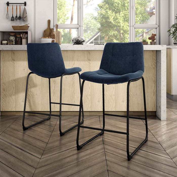 Angled set of two contemporary blue chenille counter height stools with black bases in a room with accessories