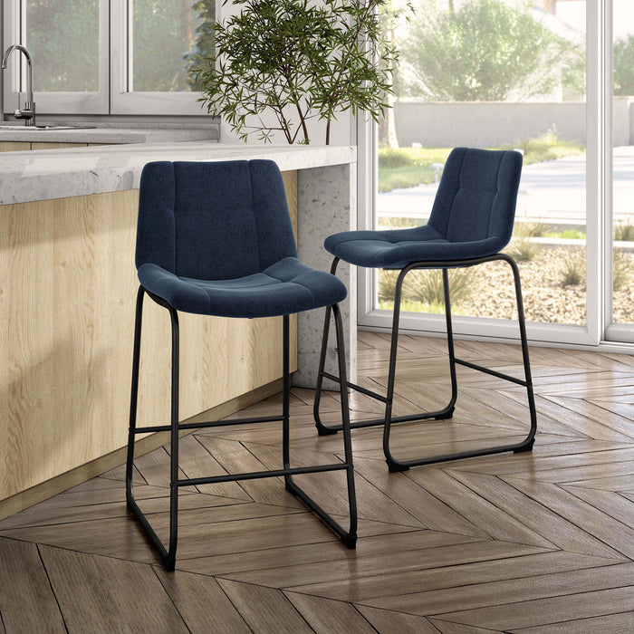 Angled set of two contemporary blue chenille counter height stools with black bases in a room with accessories