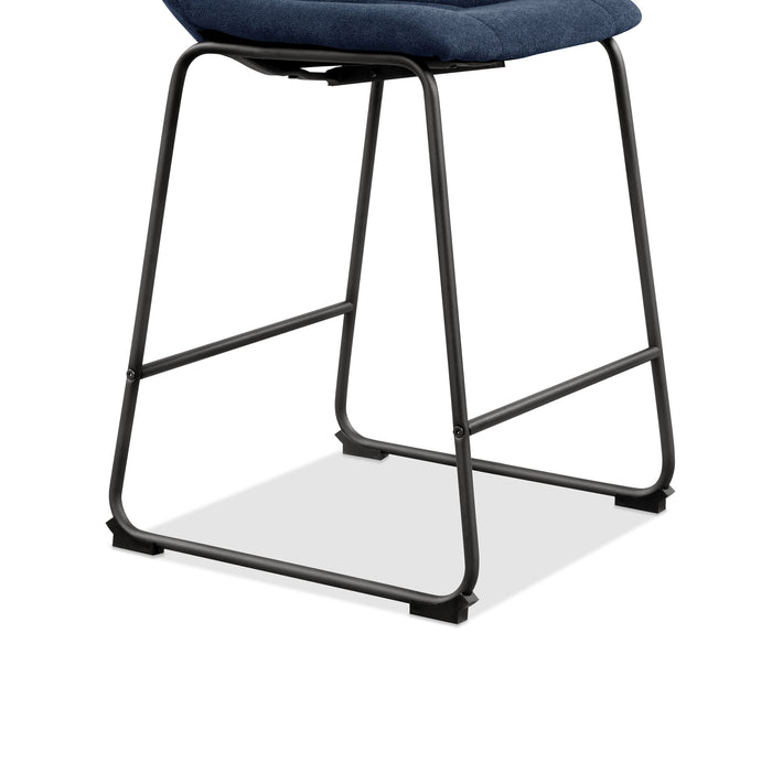 Right facing close up single view of the base on a set of two contemporary blue chenille counter height stools with black bases on a white background