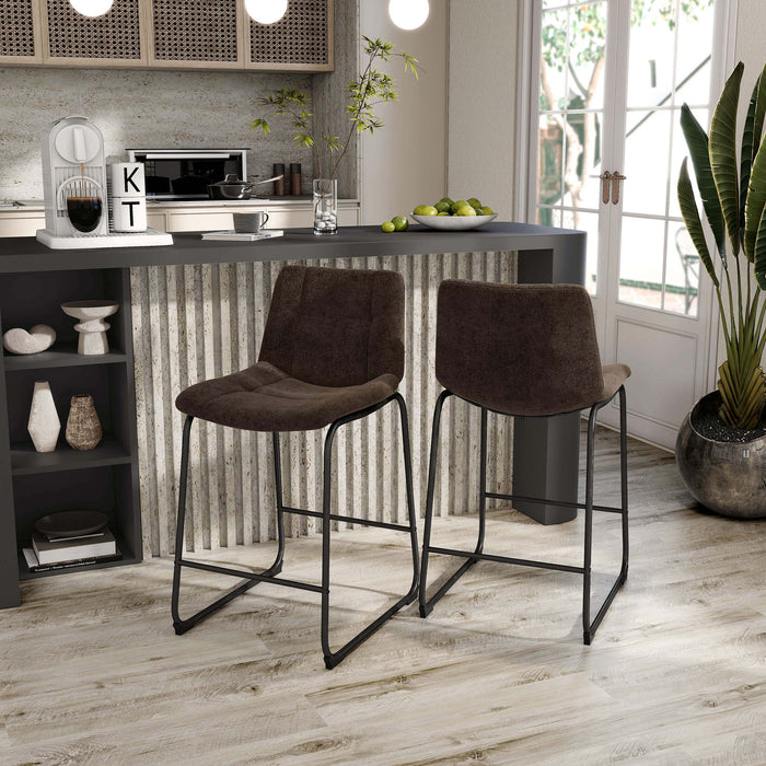 Angled set of two contemporary brown chenille counter height stools with black bases in a room with accessories