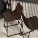 Angled bird's eye view of a set of two contemporary brown chenille counter height stools with black bases in a room with accessories