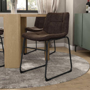 Angled set of two contemporary brown chenille dining side chairs with black bases in a room with accessories