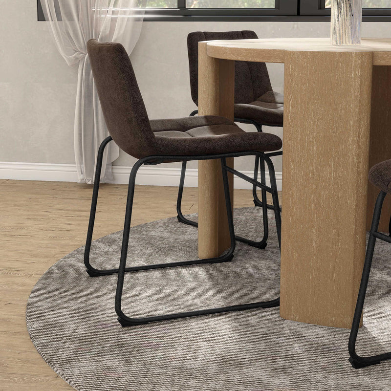Angled set of two contemporary brown chenille dining side chairs with black bases in a room with accessories