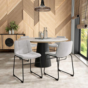 Angled set of two contemporary light grey chenille dining side chairs with black bases in a room with accessories