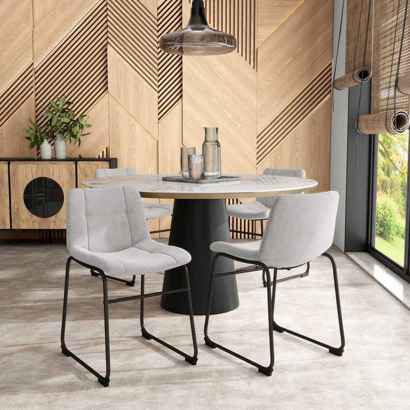 Angled set of two contemporary light grey chenille dining side chairs with black bases in a room with accessories