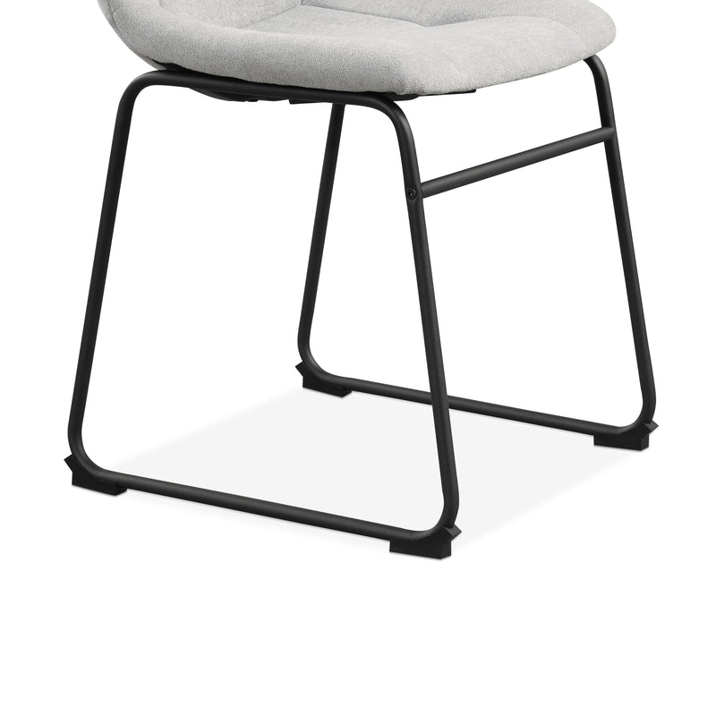 Right facing close up single view of the base on a set of two contemporary light grey chenille dining side chairs with black bases on a white background