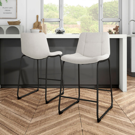Angled set of two contemporary white chenille counter height stools with black bases in a room with accessories