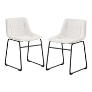 Angled set of two contemporary white chenille dining side chairs with black bases on a white background
